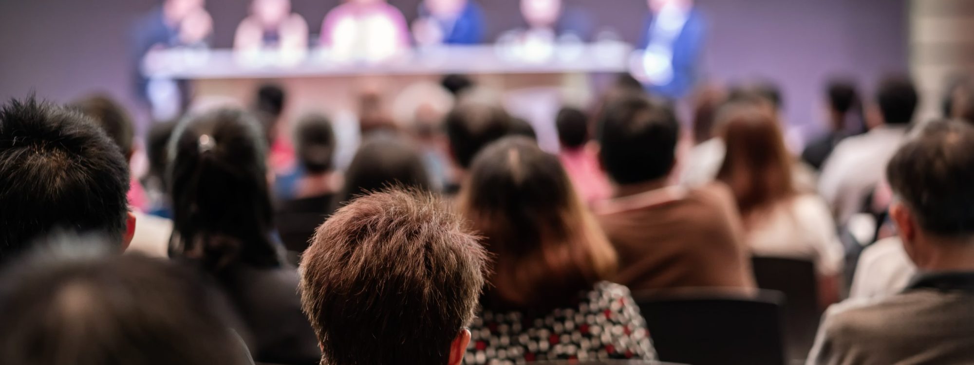 Audience in an auditorium for a corporate conference